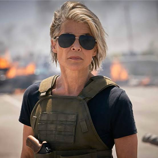 Sarah Connor wearing sunglasses and a tactical vest